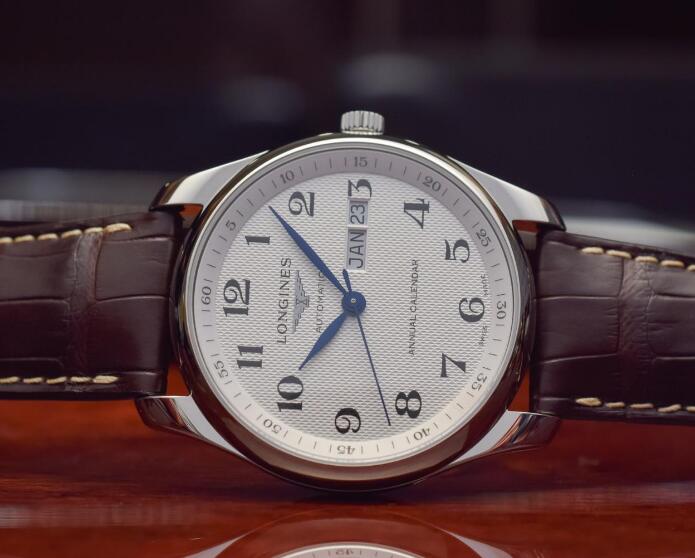 The blue hands and black Arabic numerals hour markers are striking to the silver dial.